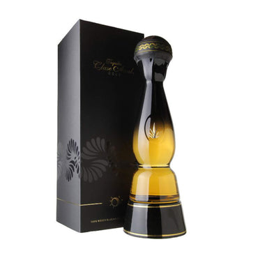 Morning sunrise, gold coloured 700ml bottle containing Clase Azul Gold tequila, positioned next to the products textured black display box.